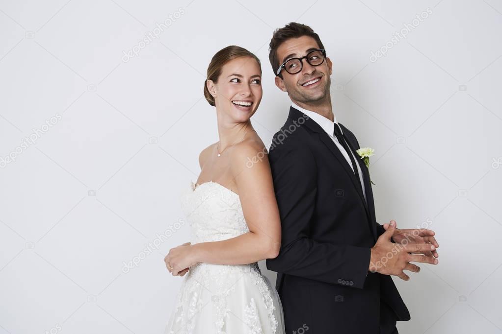 Wedding couple standing back to back 