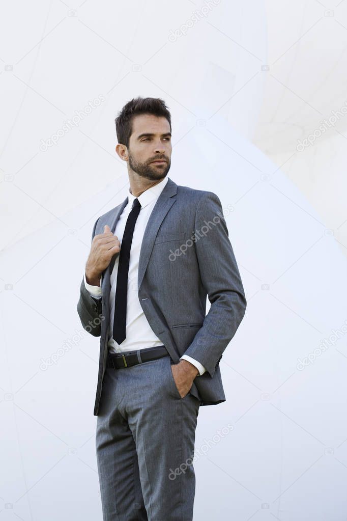 Serious businessman in smart grey suit