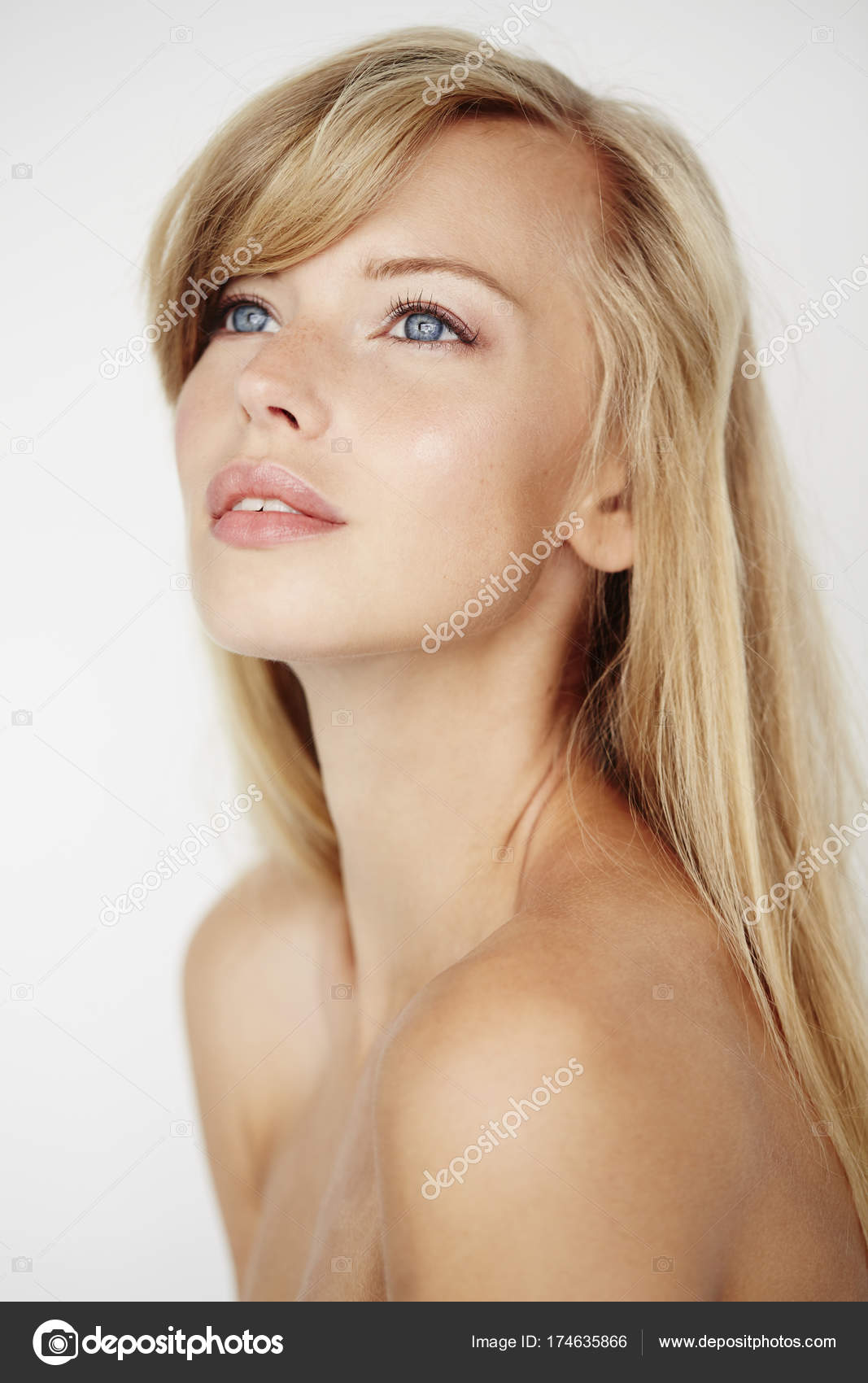 Woman looking up, nude posing on railroad