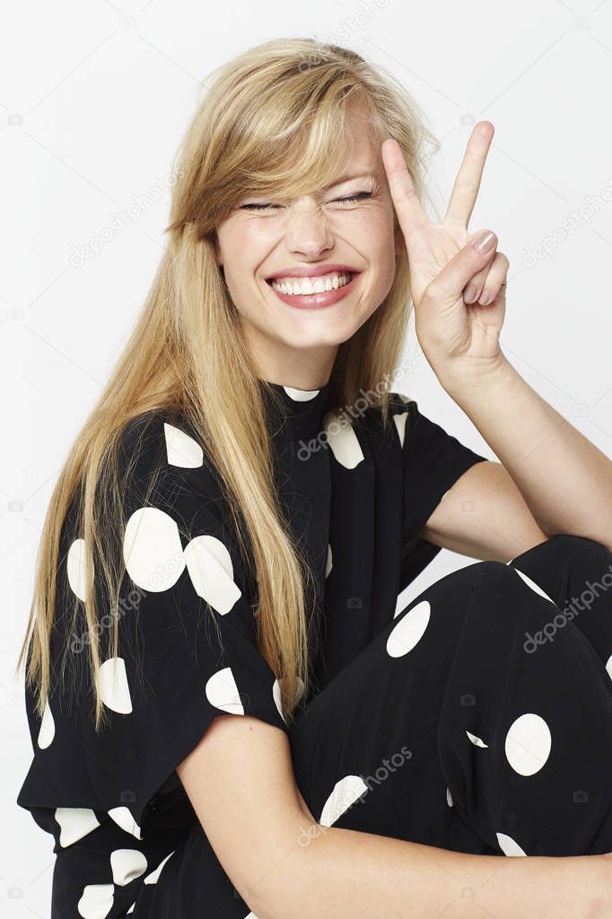 Polka dot babe with peace sign and eyes closed