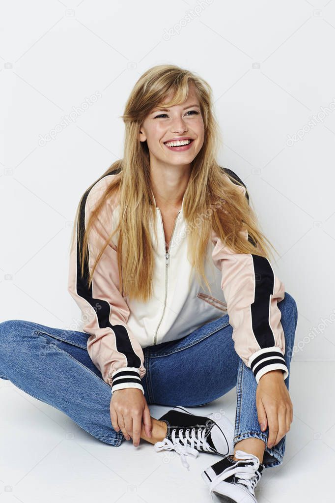 Young woman sitting down looking aside 