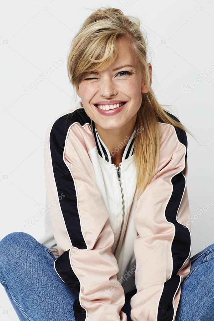 Portrait of winking girl smiling at camera