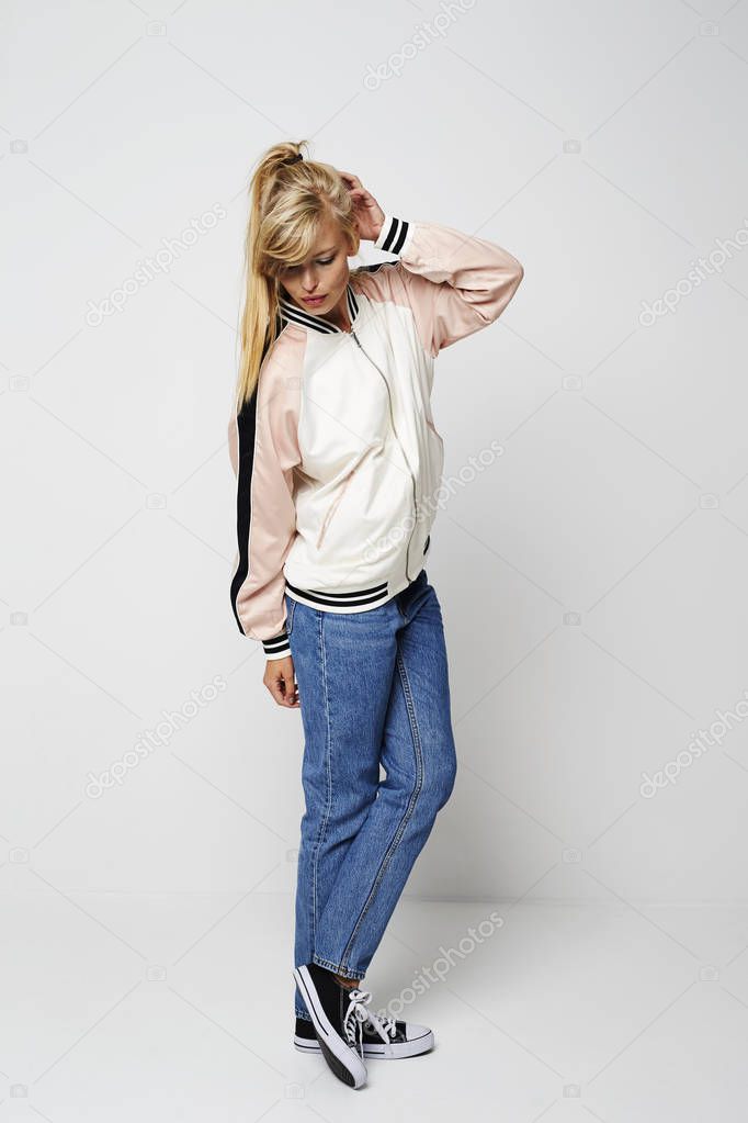 Girl posing in jacket and jeans, studio shot