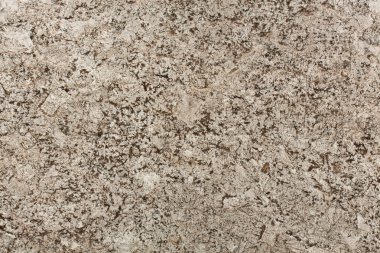 Bej ve kahverengi granit yüzey dokusu.
