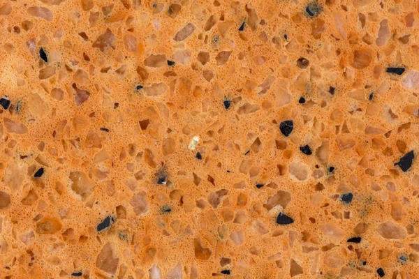Artificial rock texture. Black and orange stones.