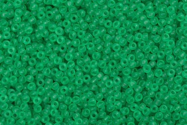 Numerous green seed beads.