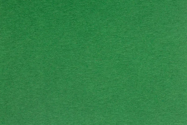 Текстурированная темно-зеленая бумага как фон . — стоковое фото