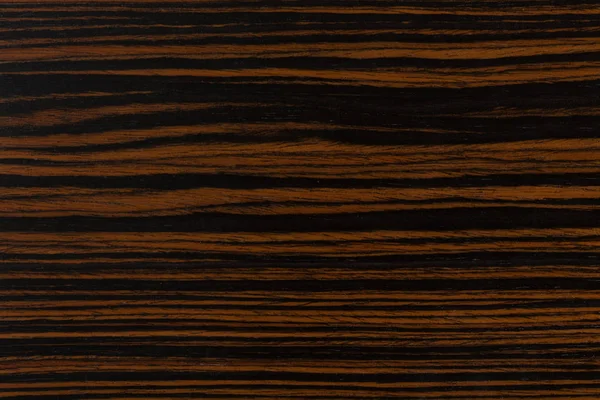 Dark natural ebony wood background.