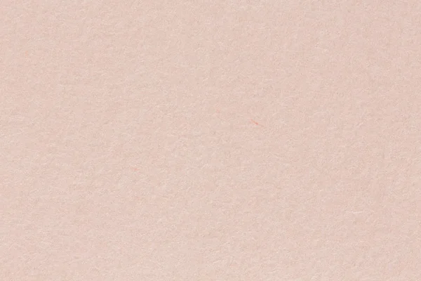 Um fundo de papel em tons quentes e esbranquiçados com uma textura fina — Fotografia de Stock