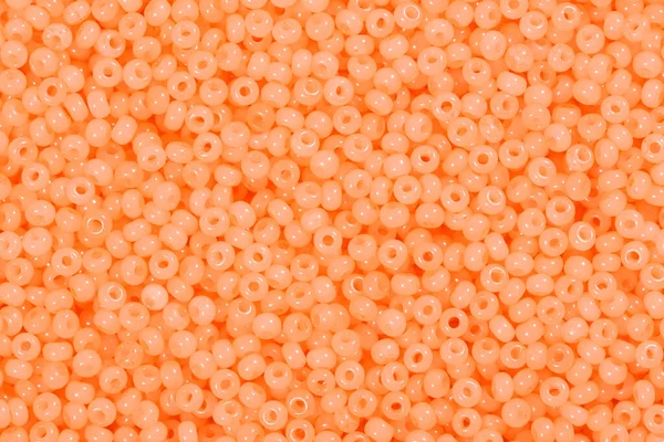 Light orange glass beads. Texture for your luxury design.