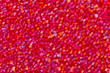 Soft defocused red, blue, orange holidays light background.