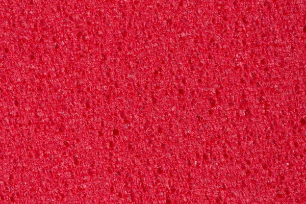 Kontrastní karmínová pěna Eva textura s pórovitostí na povrchu. — Stock fotografie