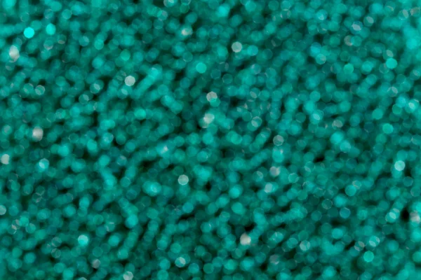 Close up of blurred dark green bokeh pattern background. — Stock Photo, Image