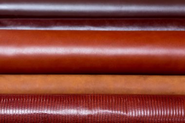 Shiny beige leather in horizontal lines. Can be used as background in art or design projects.