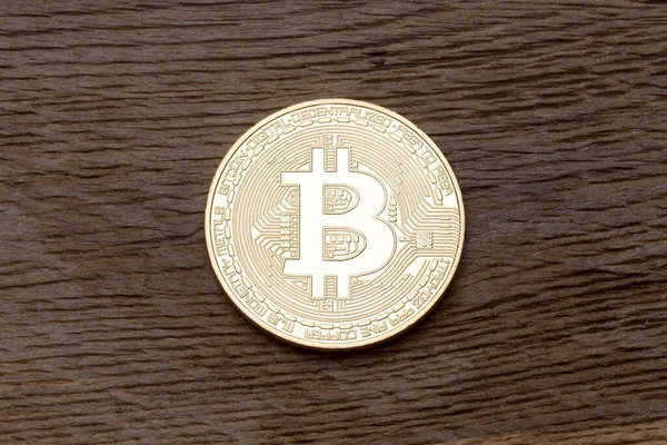 Moneda digital oro físico bitcoin en la madera . — Foto de Stock