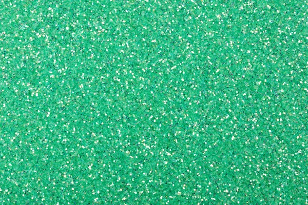 Holographic glitter texture in exquisite green tone as part of your creative design work.