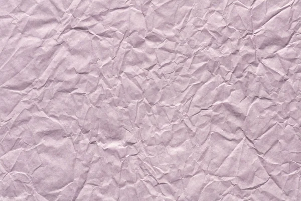 Crumpled paper background in gentle lilac color as part of new greeting card.