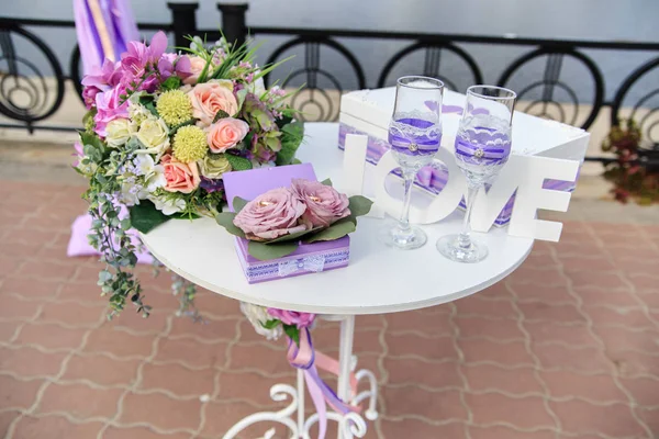 Las copas con el encaje y la caja para los anillos a la mesa a la ceremonia de boda —  Fotos de Stock