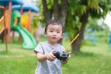 Küçük Asyalı çocuk (han kontrol bir radyo kontrol holding