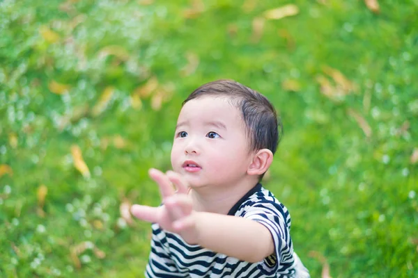 Close-up little Asian boy looking up somewhere and thinking with — Stock Photo, Image