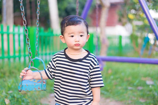 Sad little Asian kid at the playground under the sunlight in sum — Stock Photo, Image