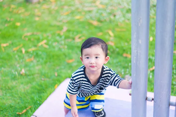 Primer plano pequeño chico asiático mirando hacia arriba en algún lugar y pensando con — Foto de Stock