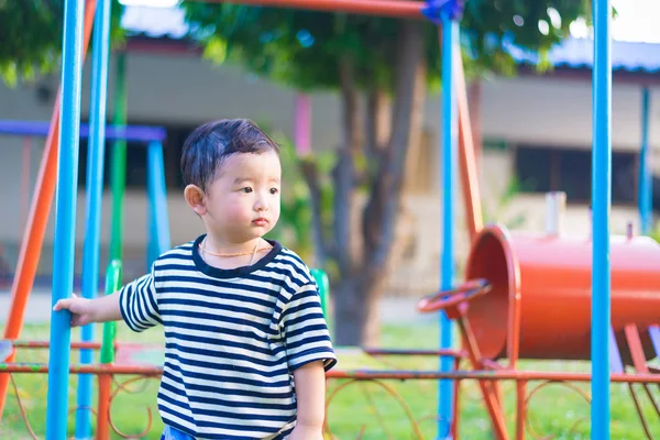 Sad little Asian kid at the playground under the sunlight in sum — Stock Photo, Image