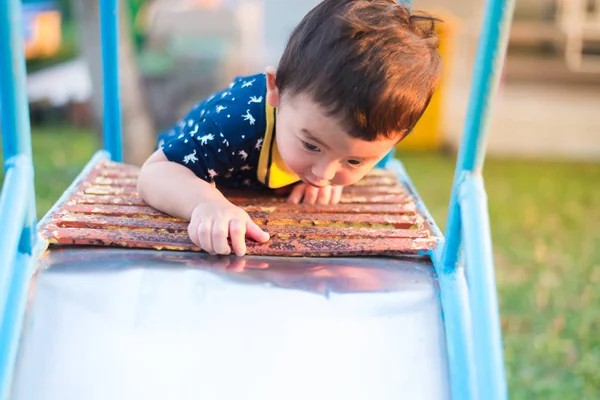 Asian kid goes up the stairs in the park. concept of growing up.