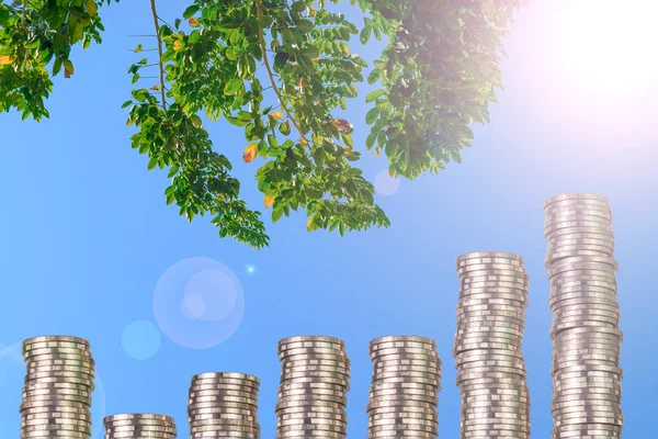 Columns of coins, piles of coins arranged as a graph on blue sky