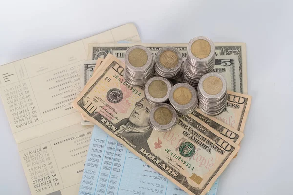 Piles of coins dollar currency and account book  on white backgr — Stock Photo, Image