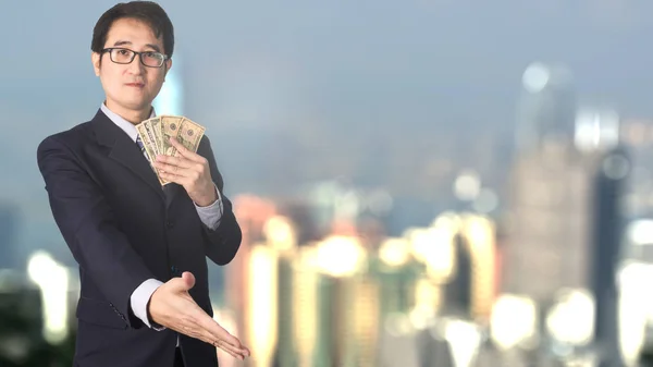 Double exposure of businessman shaking hand on blurred building — Stock Photo, Image