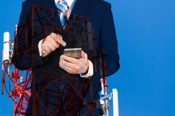 Подвійна експозиція бізнесмена з використанням смартфона на блакитному небі і — стокове фото