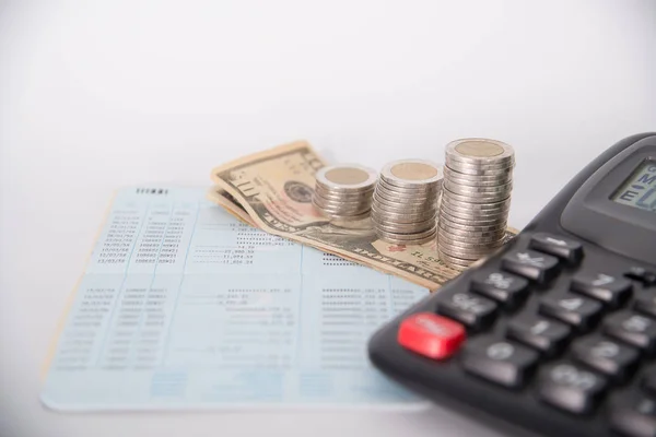 Piles of coins dollar currency and account book with calculator — Stock Photo, Image