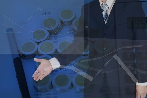 Double exposure of businessman shaking hand with stack of coins