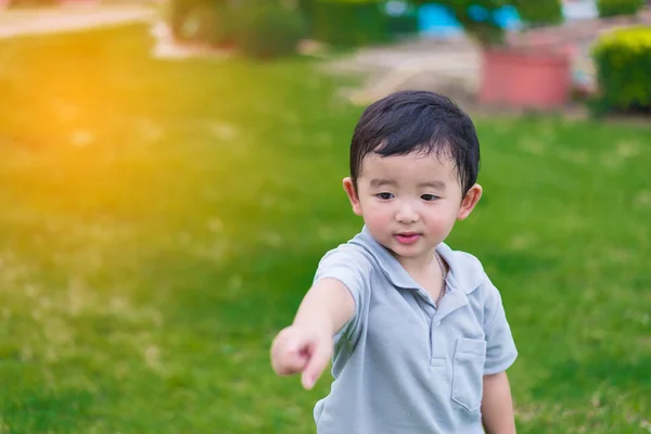 Little Asian kid at the playground under the sunlight, shallow D — Stock Photo, Image