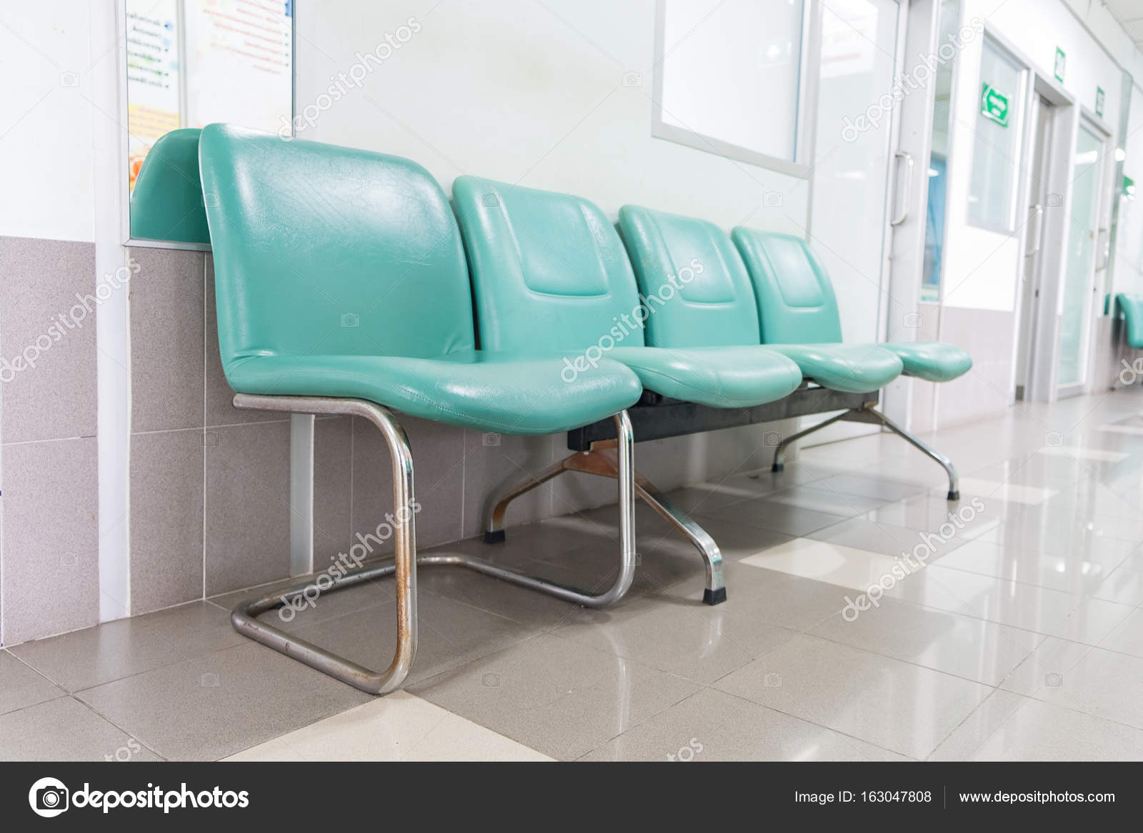 empty green waiting chair in the hospital hallway 163047808