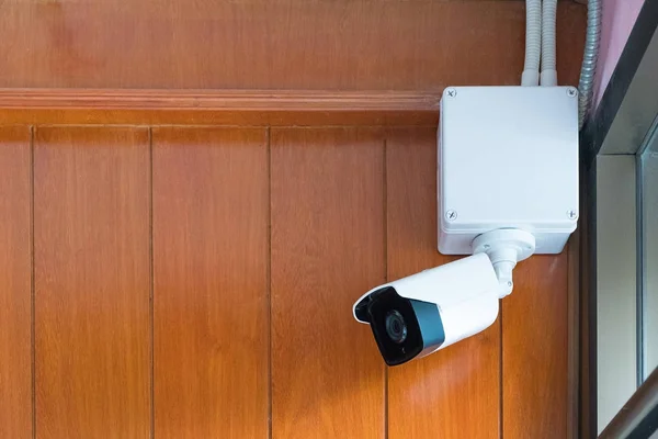 Камера безпеки або камера відеоспостереження на дерев'яній стіні в кімнаті . — стокове фото