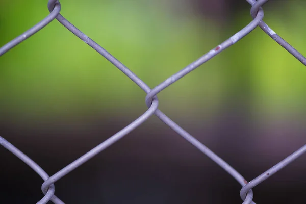 Rusty Chain Link Fence of steel netting on blur background. — Stock Photo, Image