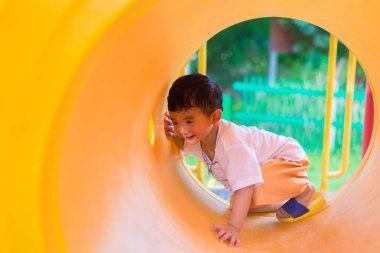 Oynama ve playg, sarı tünelde gülümseyen sevimli Asya çocuk