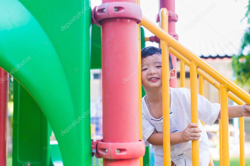 Asian kid goes up the stairs in the park. concept of growing up.