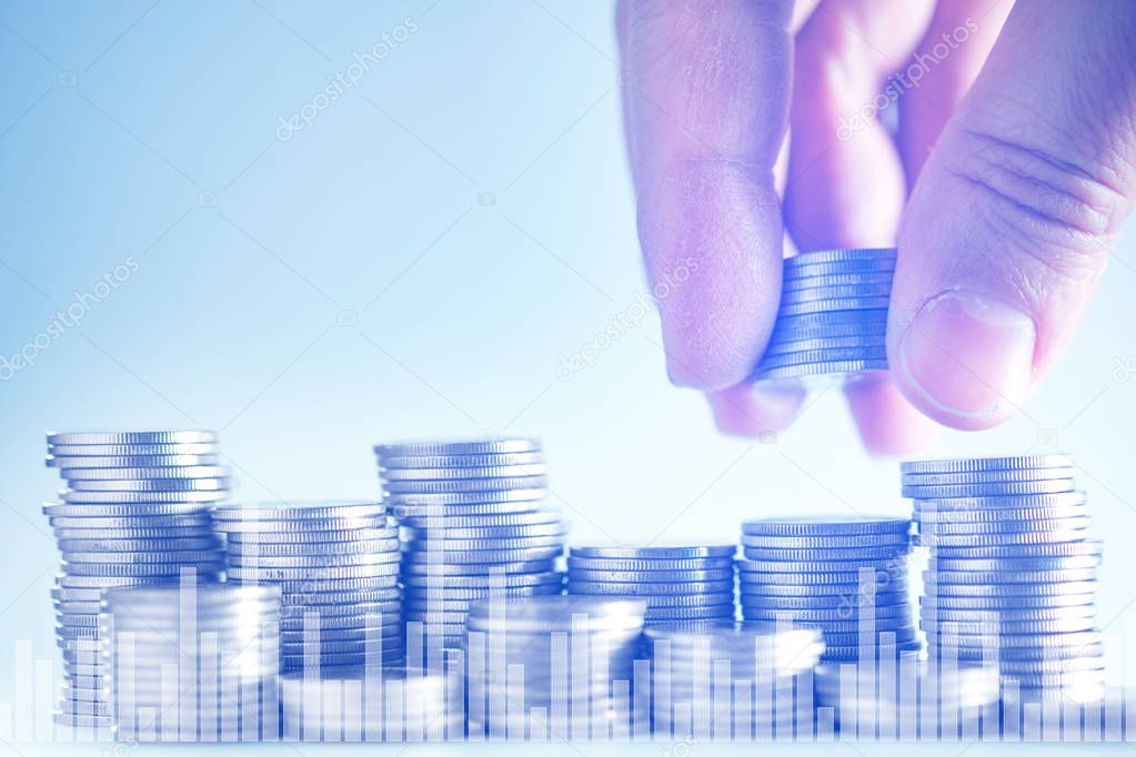 Double exposure of hand put money coins to stack of coins with f