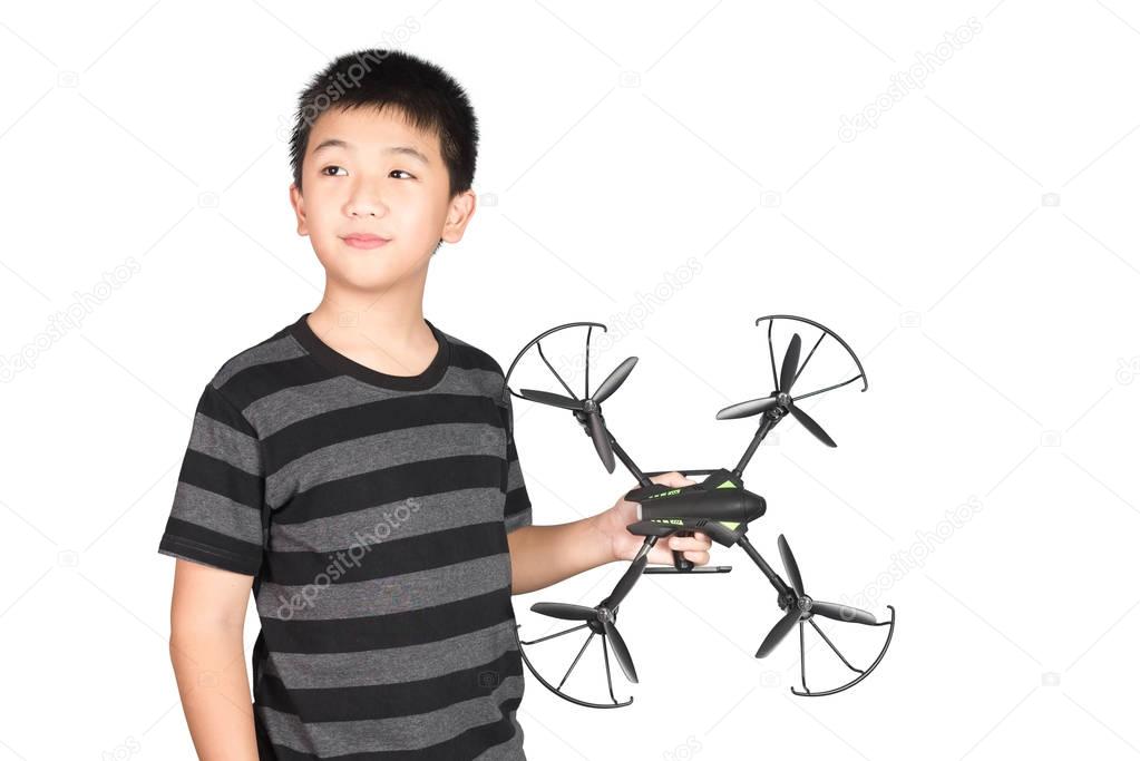 Asian boy holding hexacopter drone or quadrocopter toy in hand, 