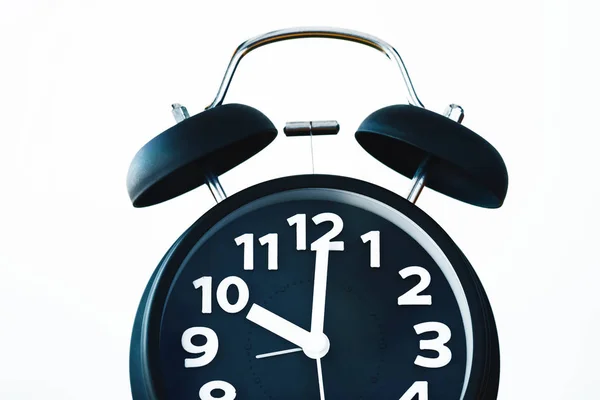 Primer plano del reloj despertador vintage de color negro en la pared blanca, tiempo —  Fotos de Stock