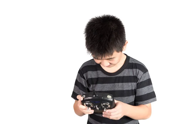 Asiático niño sosteniendo radio mando a distancia auricular para helicóptero, d —  Fotos de Stock
