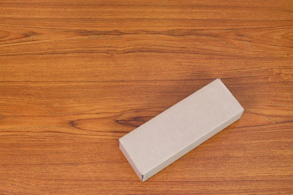 Paquete vacío caja de cartón marrón para artículos largos en mesa de madera — Foto de Stock