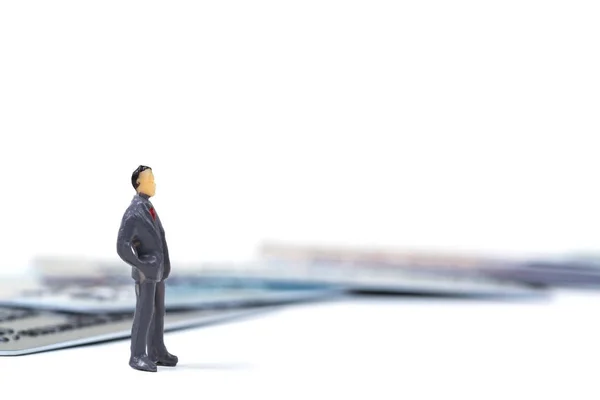 Figure miniature businessman or small people standing with stack — Stock Photo, Image