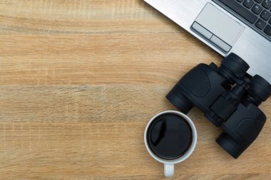 Dizüstü bilgisayar ya da defter ve dürbün, hesap makinesi ve fincan