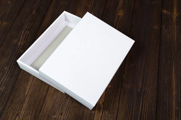 Empty white gift box or tray for mock up on dark wooden table wi — Stock Photo, Image