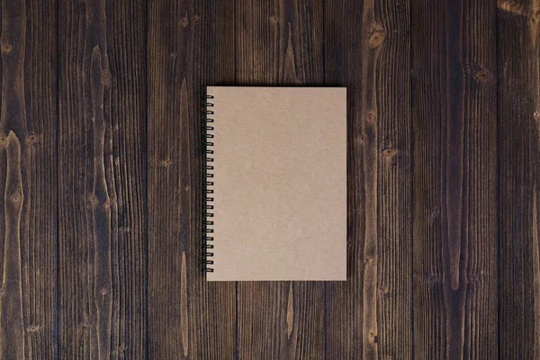 Cuaderno sobre tabla de madera vista superior con espacio para copiar . — Foto de Stock
