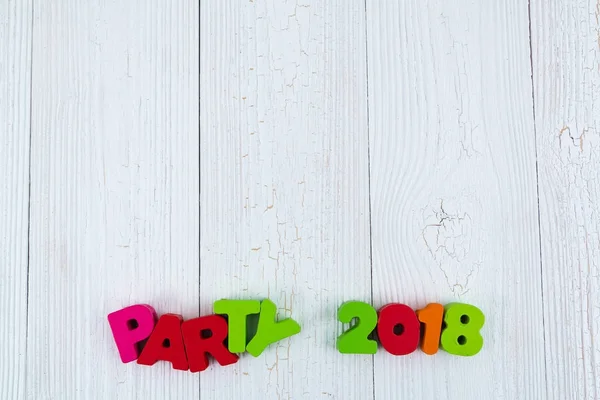 Party 2018 colorful wooden text on white wooden desk with Christ